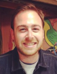 A man smiles at the camera
