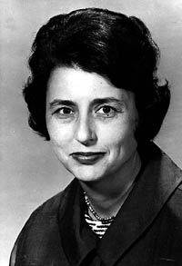 A woman looks into the camera in a black and white photo