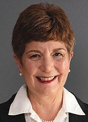 A woman with short hair smiles into the camera